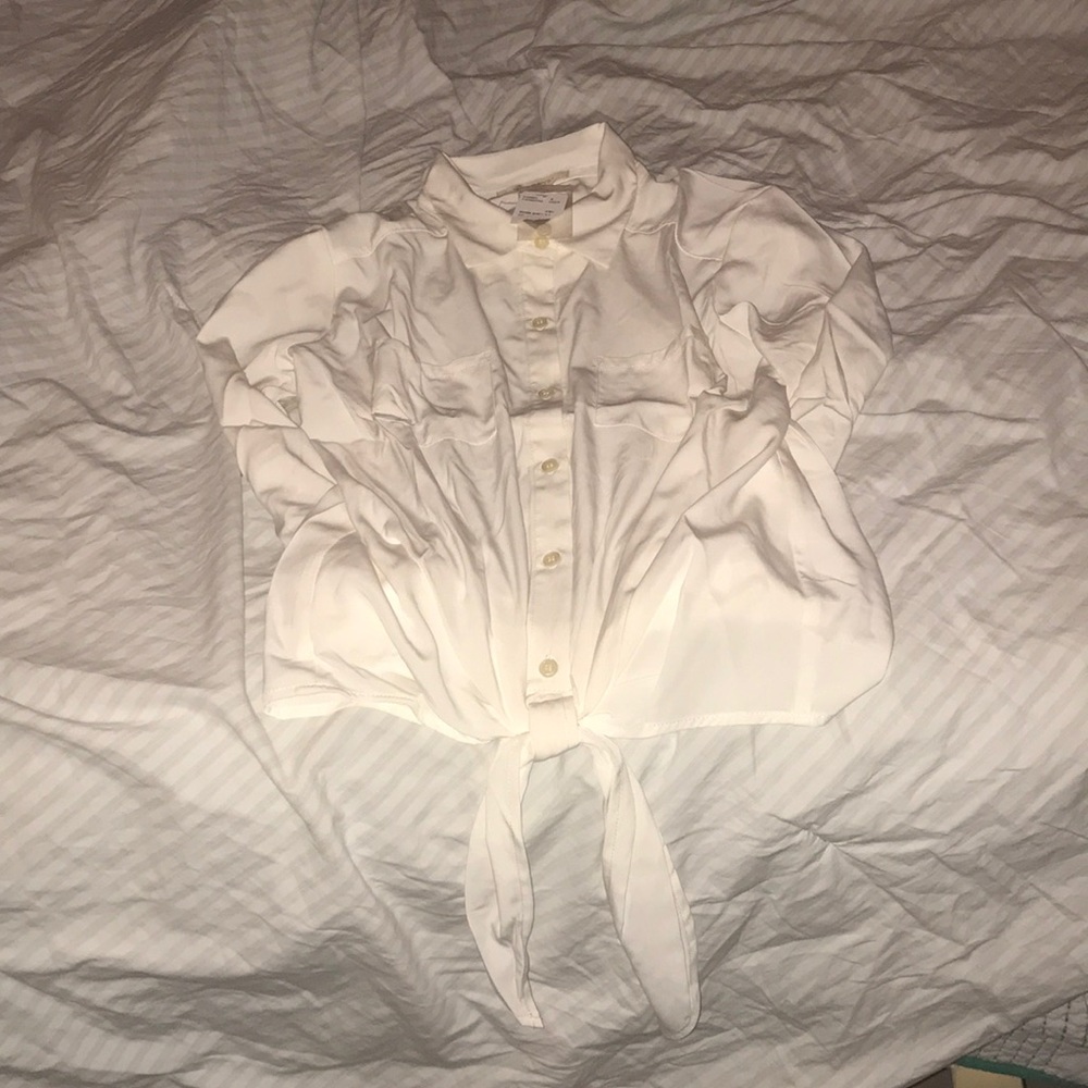A cream color woven long sleeve blouse .